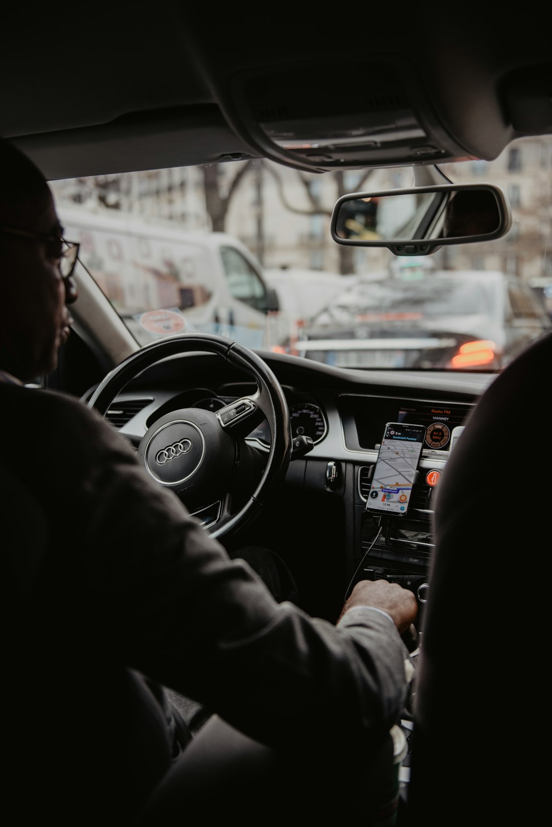 A professional driver at the wheel using the GetMeDriver Driver App